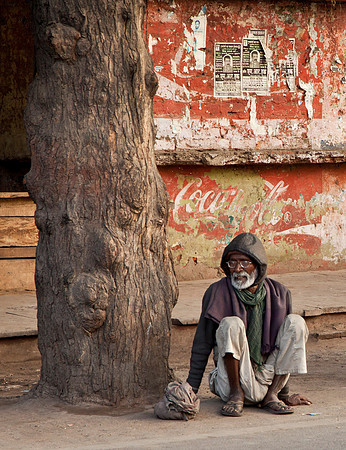 Man Squatting Curbside